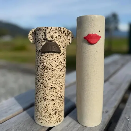 Two character bud vases with sculpted faces