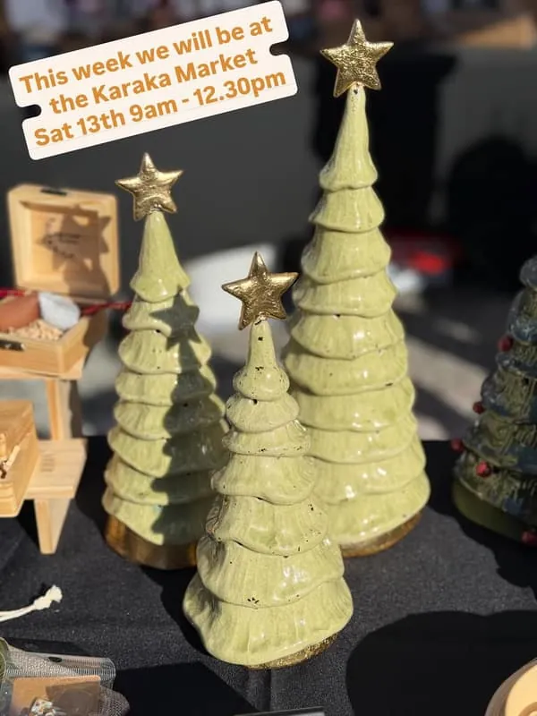 Sara Thomson Ceramics market stall with ceramic Christmas trees and a sign for the Karaka Market